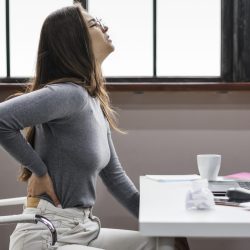 side-view-woman-having-backache-while-working-from-home side-view-woman-having-backache-while-working-from-home